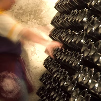 Auf dem Weingut Montenisa werden Franciacortaflaschen im Rüttelpult gedreht