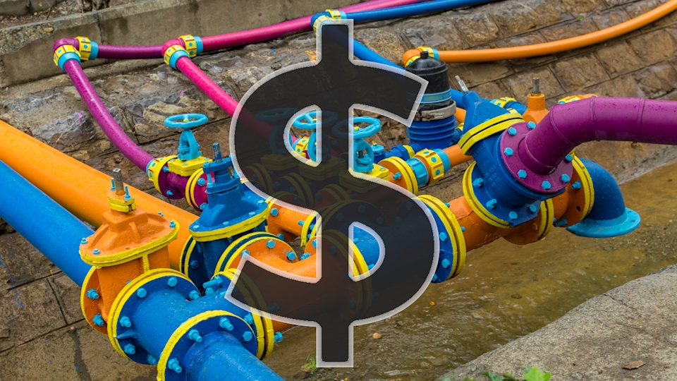 A complex intersection of pipes which are painted blue, orange, yellow, and magenta, with a dollar sign superimposed on it