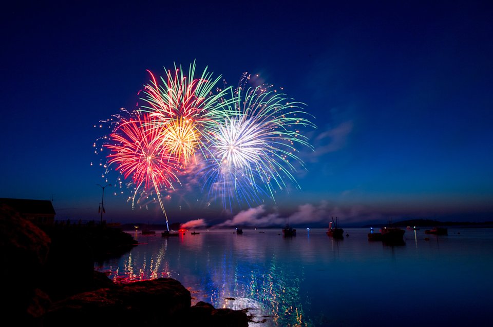 Photo of fireworks over the coast from the water