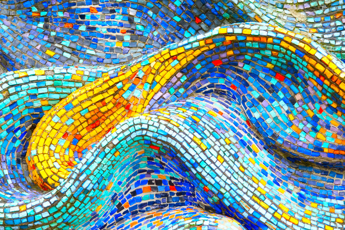 A swirly, 3-dimensional mosaic featuring primarily blue/teal and yellow/orange pieces