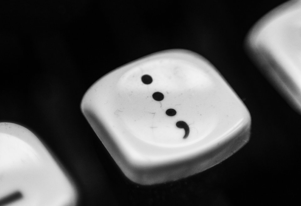Black and white photo of the semicolon key on a typewriter