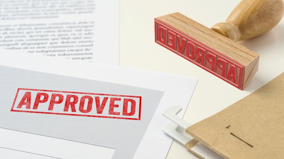 a red "approved" stamp has been stamped on a document