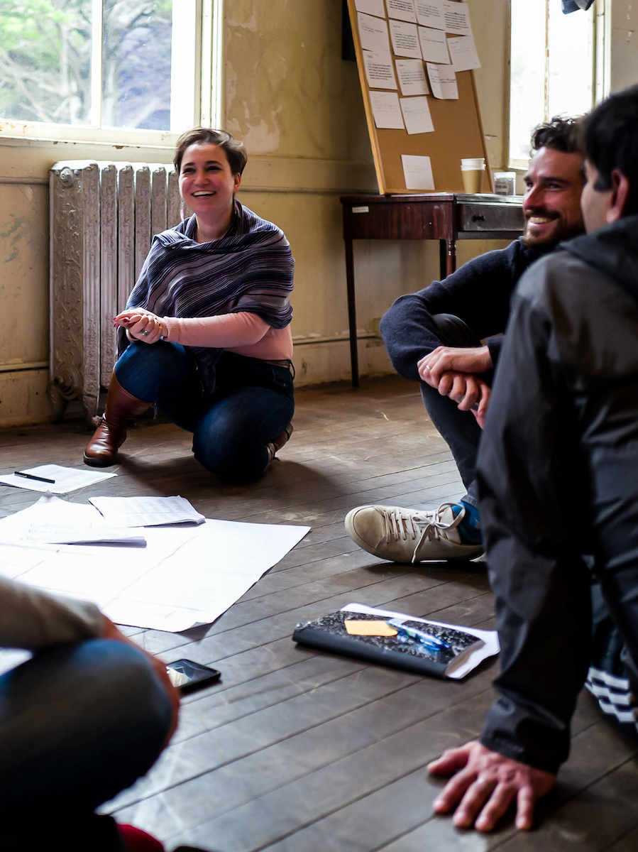 Laughing as a group while sitting on floor in circle