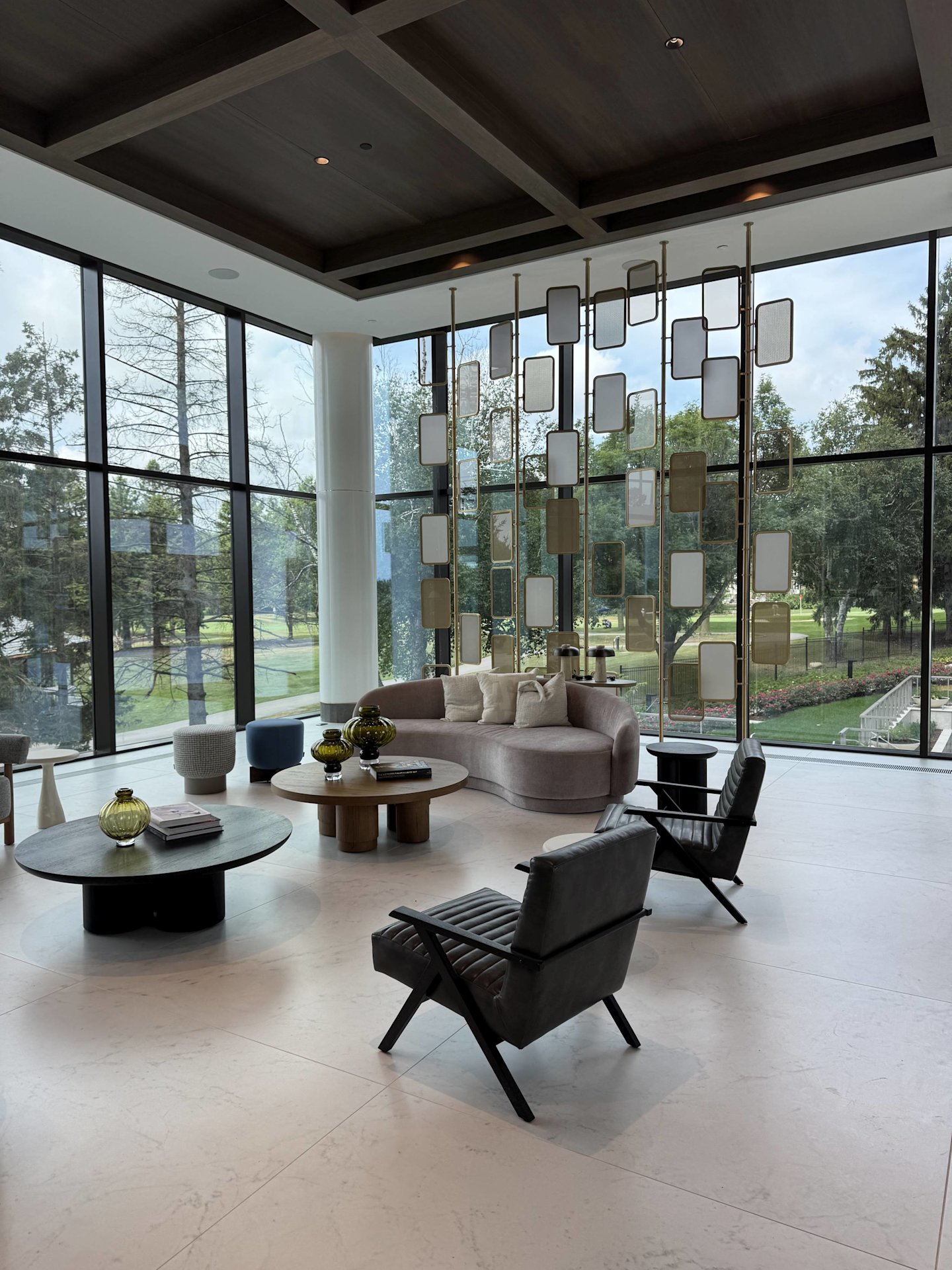 Royal Bayview lobby with refined design elements, lounge furniture, and a golf course view.