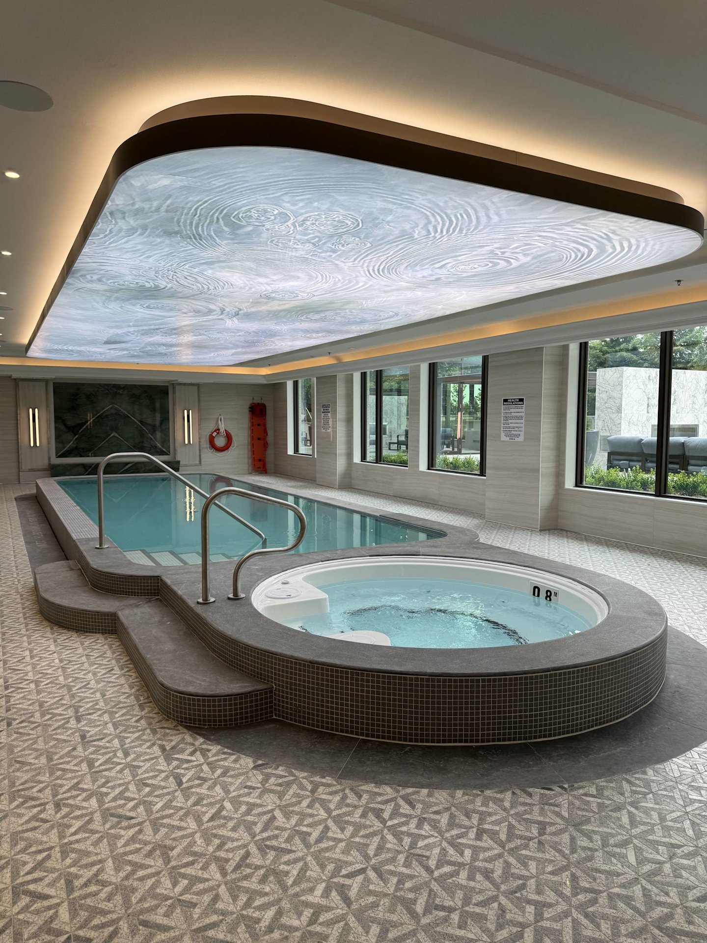 Royal Bayview's modern pool and hot tub architecture with a glowing overhead design feature.