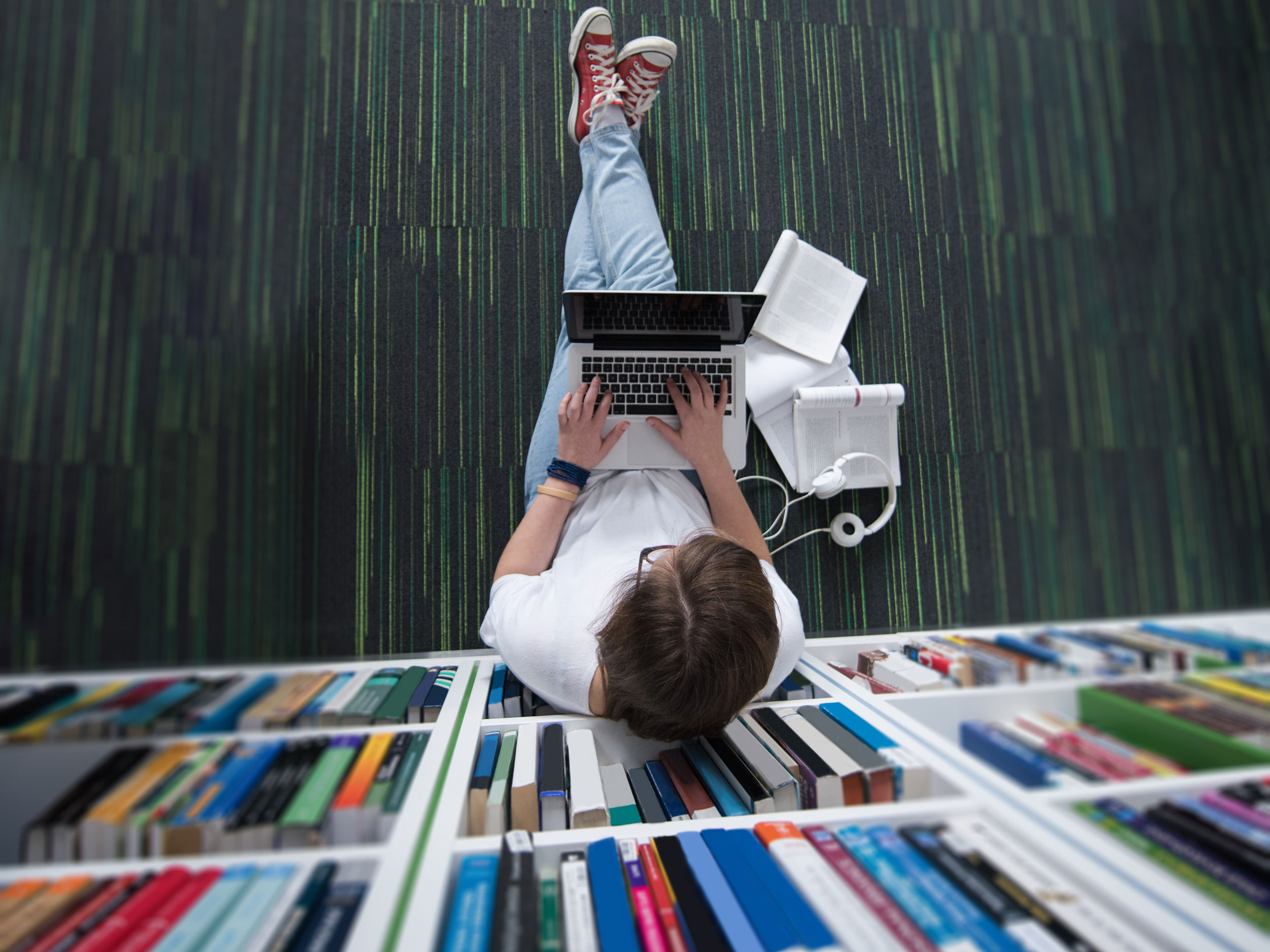 Man Sitting on Floor Typing on Laptop