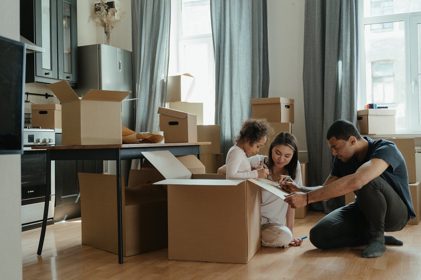 Family moving in with moving boxes