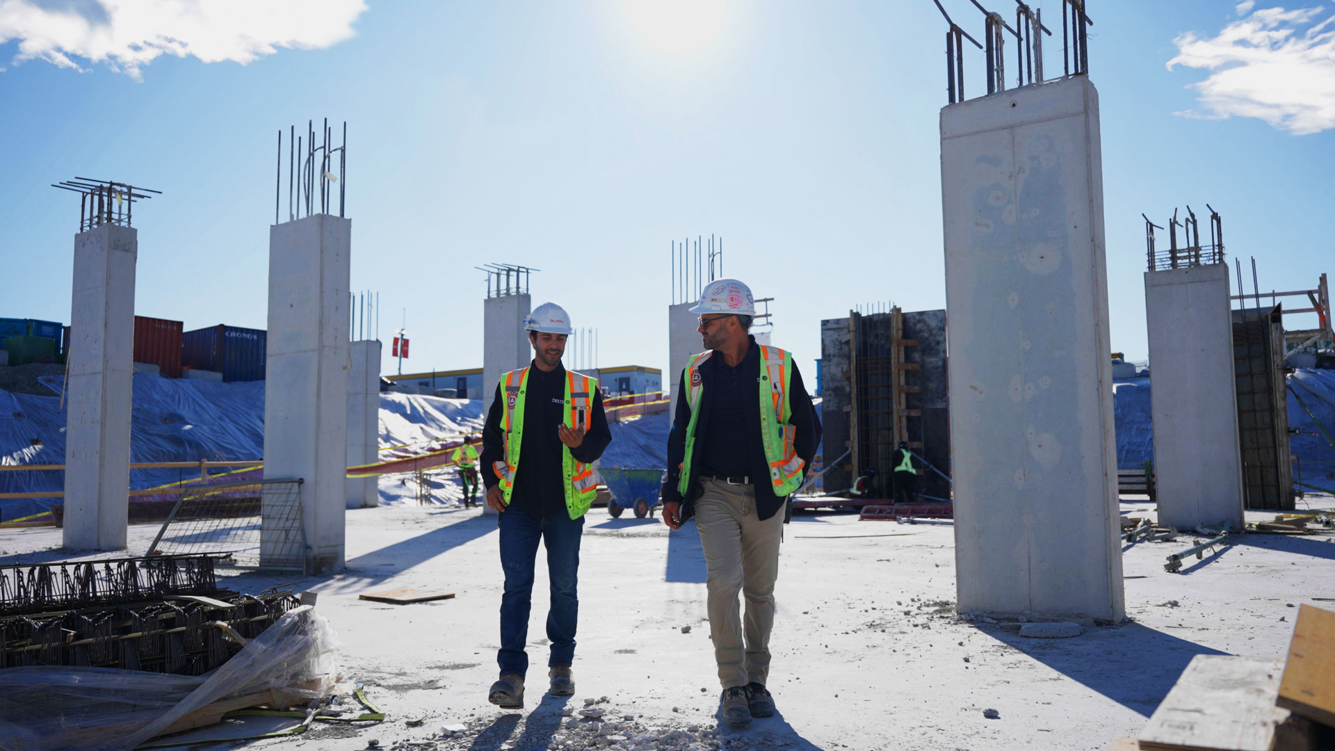 Construction team walking through forming progress