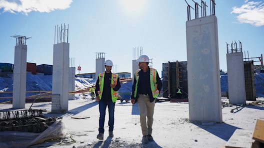 Construction team walking through forming progress