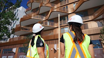 Construction team looking at the exterior of Aqualuna at Bayside Toronto