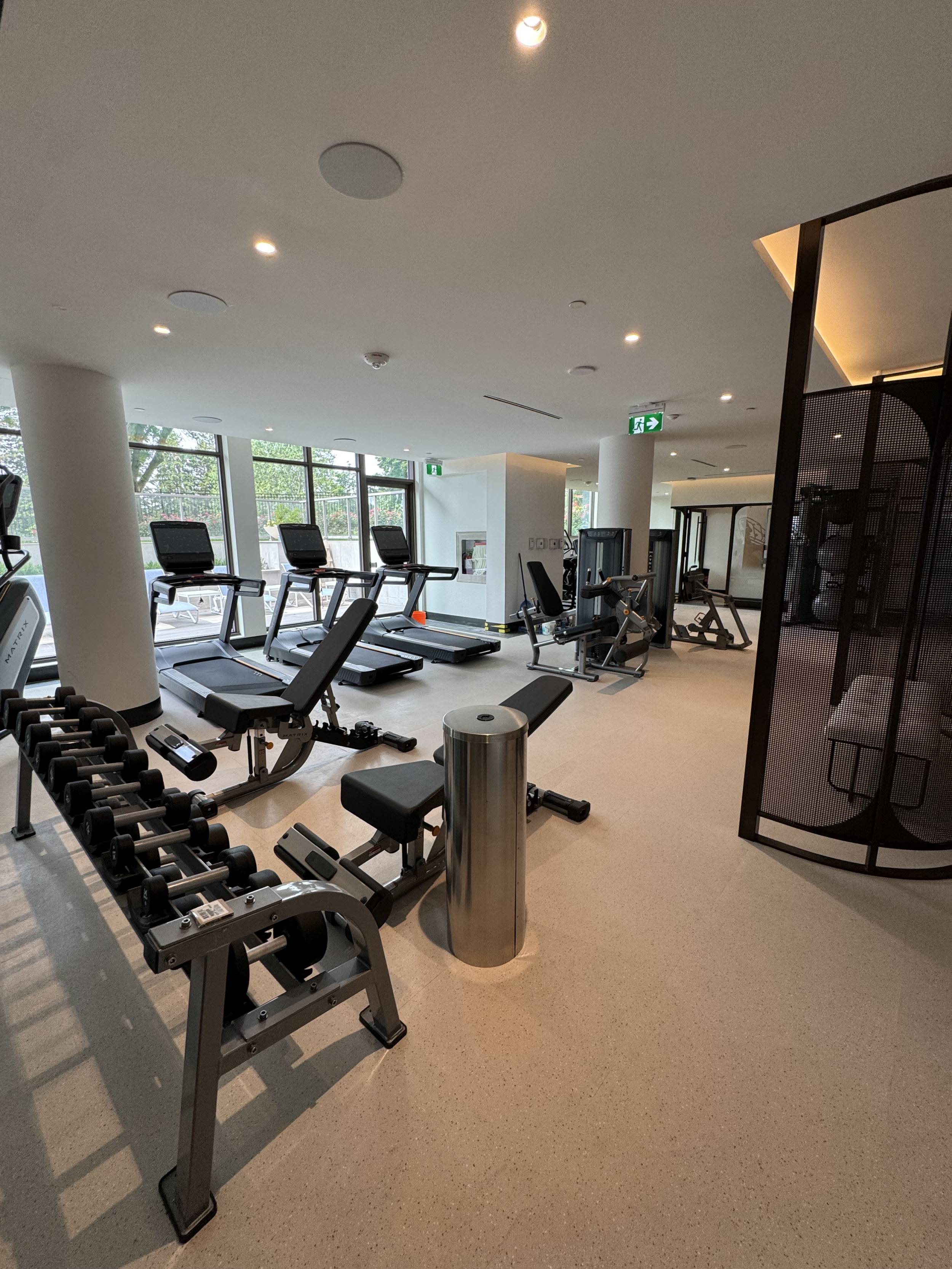 Royal Bayview gym featuring free weights, treadmills, stair climber, and static machine with a view facing the Ladies' Golf Club of Toronto.