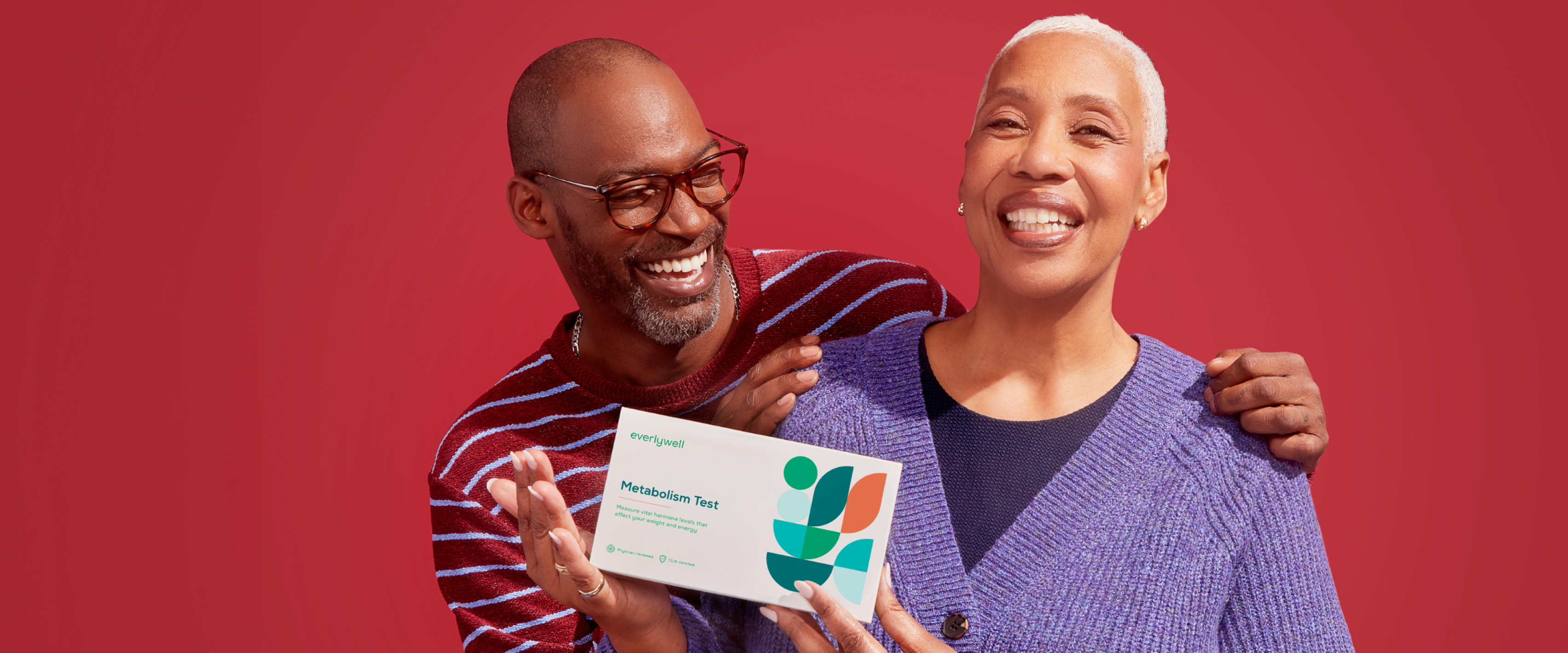 Man hugging a woman holding Metabolism at-home test