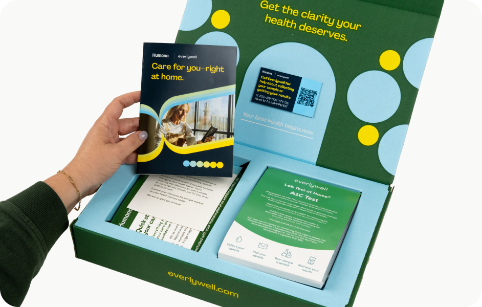 Hand holding A1c kit instructions about to collect sample