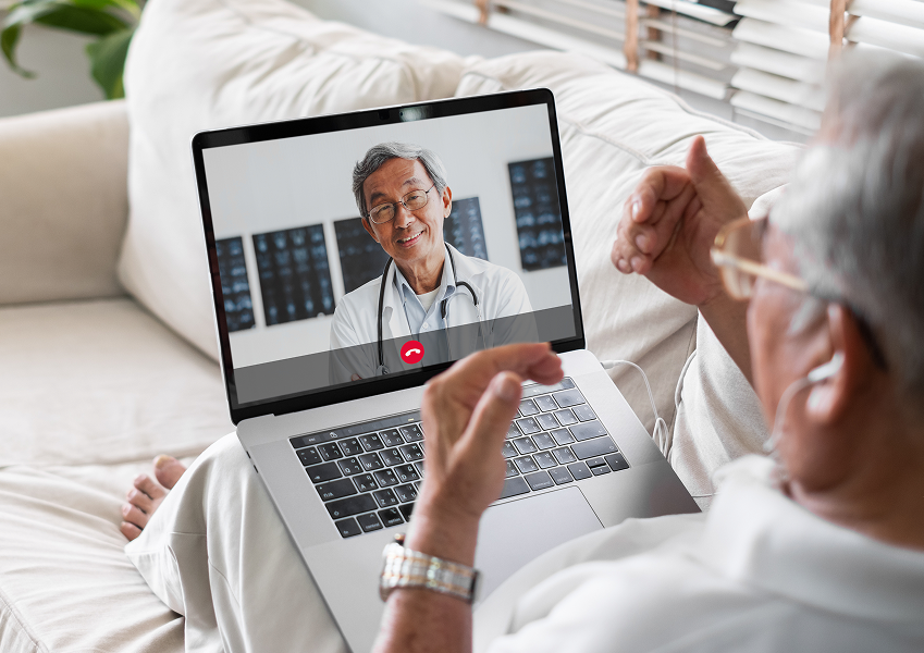 Senior man speaking with a provider on his computer