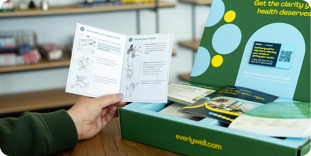 Hand holding A1c kit instructions