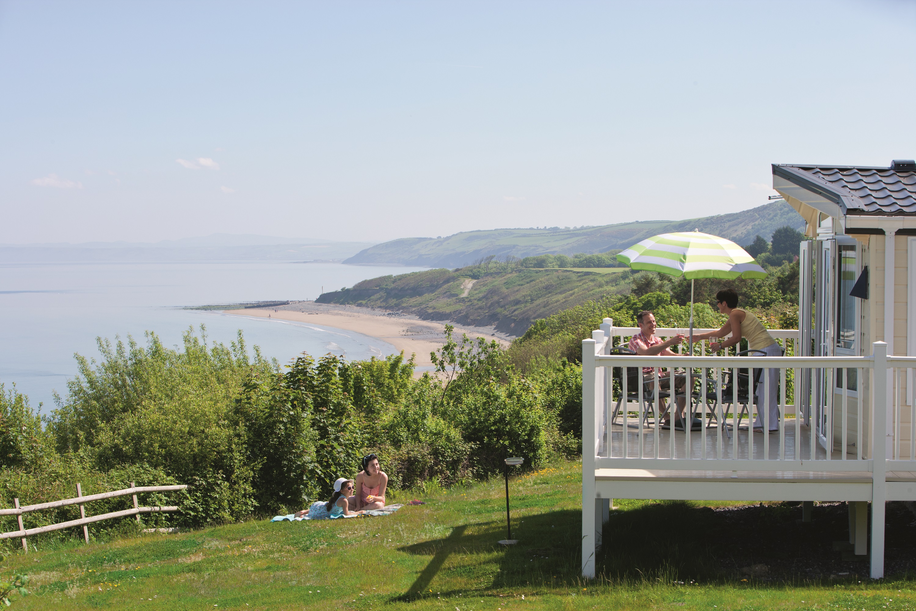 Family talking with each other on their caravan's decking