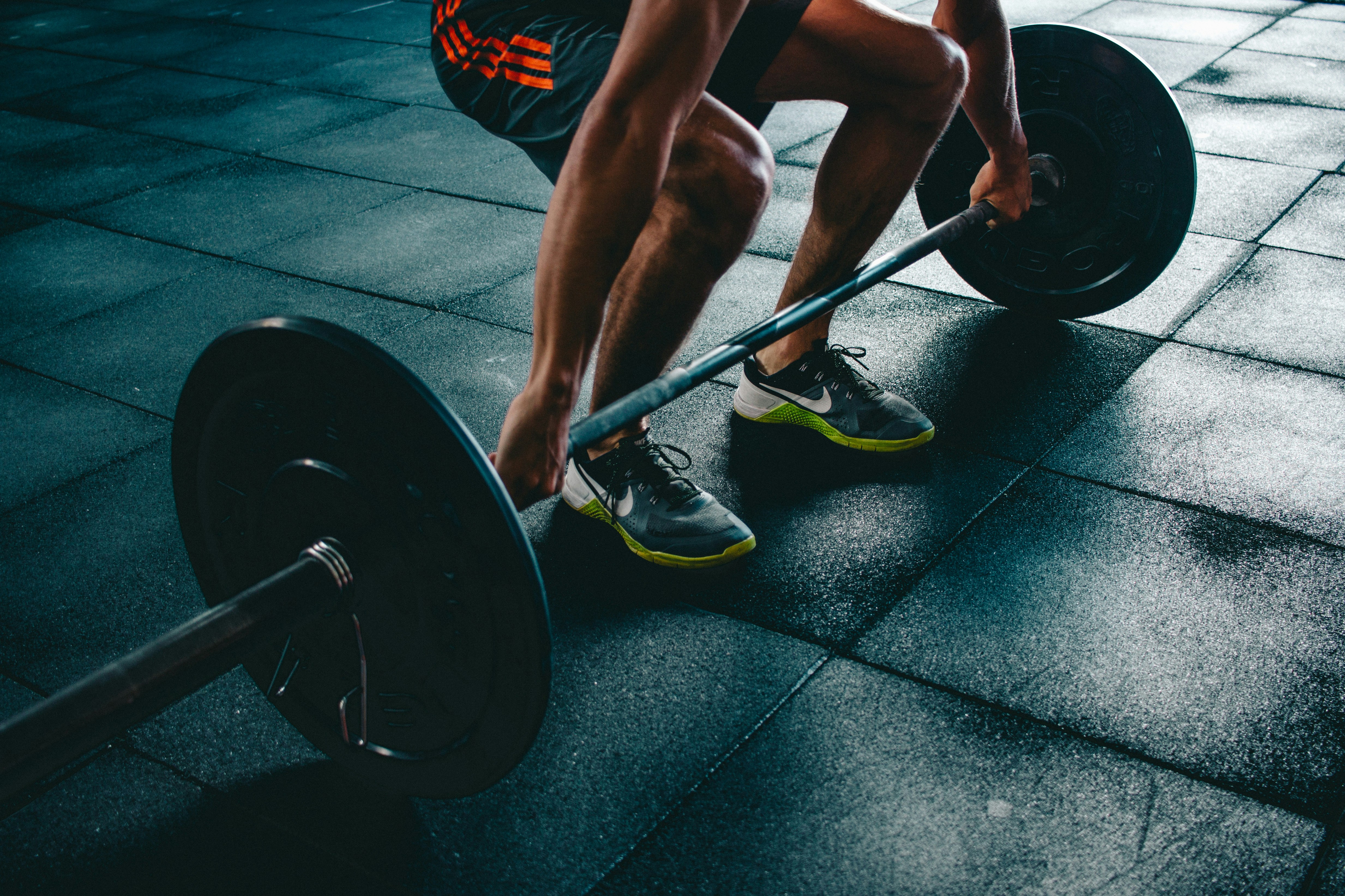 A man weightlifting in a gym.