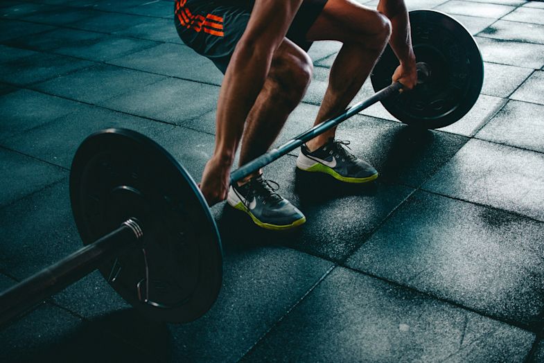A man weightlifting in a gym.