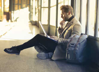 Man sitting on the floor at the airport - Extraordinary circumstances - Flight delay