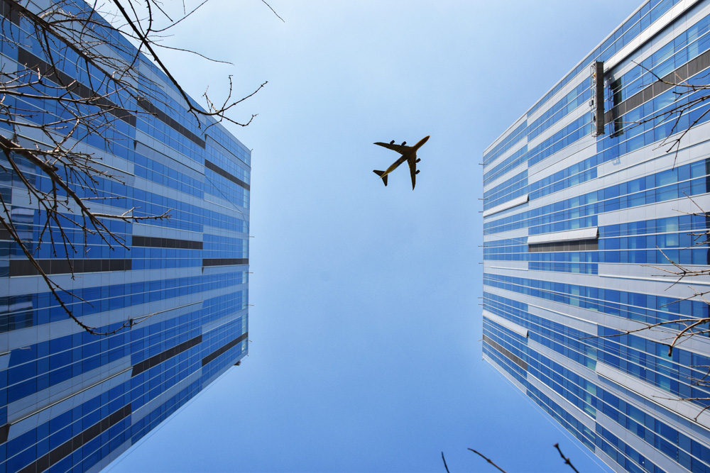 Aircraft flying over skyscrapers