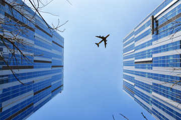 Aircraft flying over skyscrapers