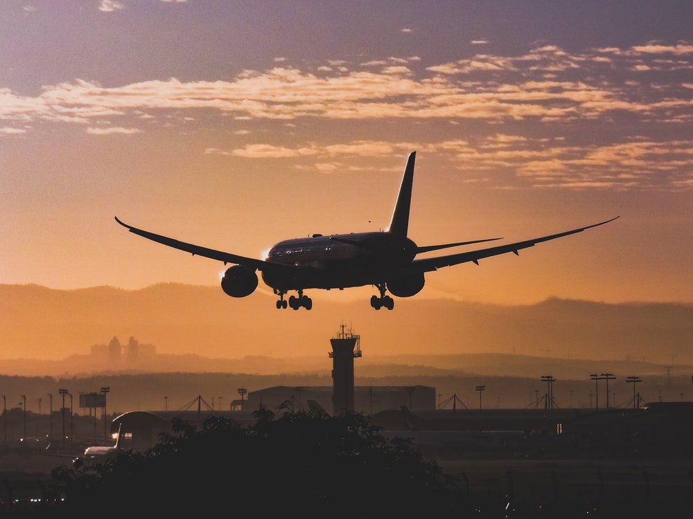 Plane flying low over a city