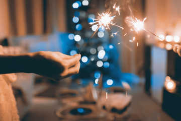 Sparklers held in hands, during the Christmas time