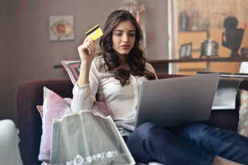 Woman holding a bank card - Best travel debit card in Europe featured photo