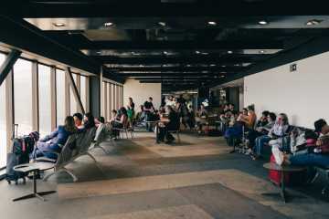 People waiting for their flight at a gate at an airport