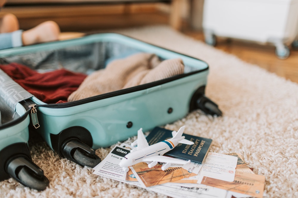 Suitcase and passport on the floor