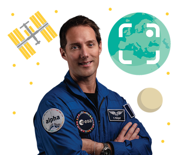 Thomas Pesquet Standing in front of illustrated graphics
