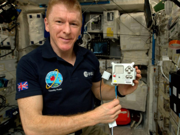 Astronaut Tim Peake holding an Astro Pi computer