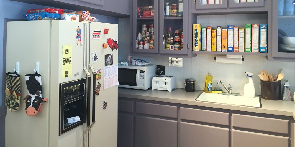 Jerry Seinfeld's sitcom apartment kitchen with rows of cereal boxes stacked above the sink