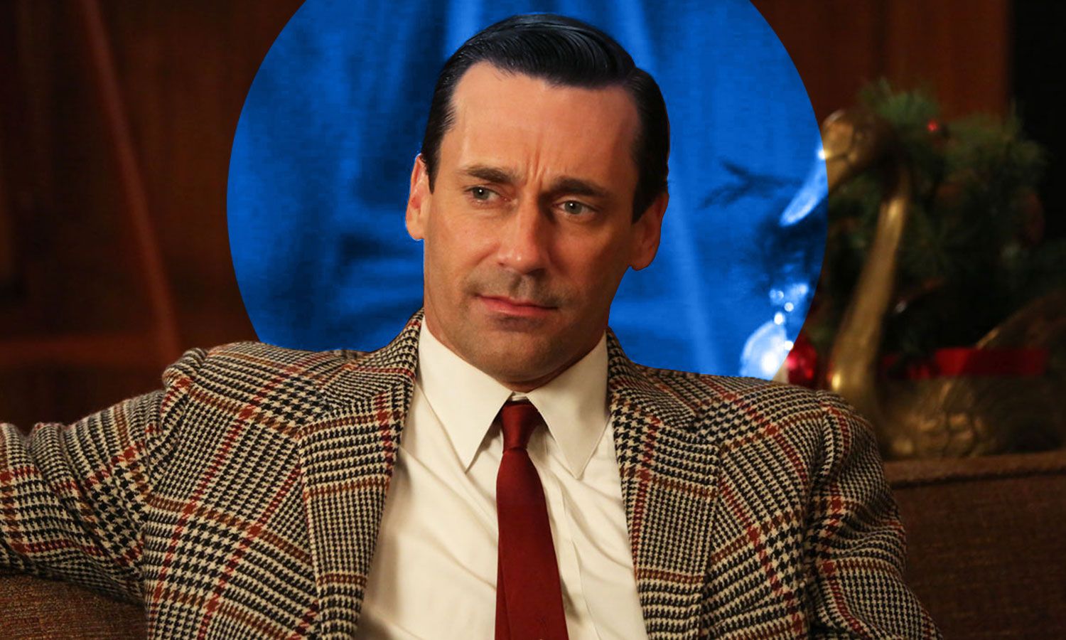 Man with dark slicked-back hair showing a maturing hairline that sits higher than a juvenile hairline
