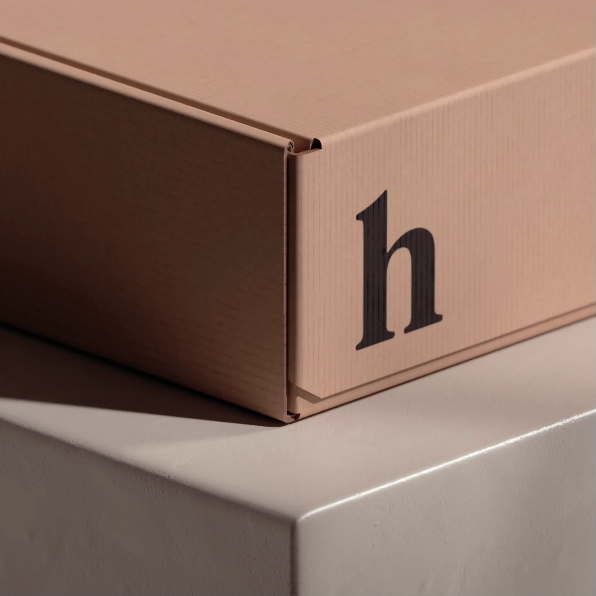 A plain cardboard box marked with a Hims logo