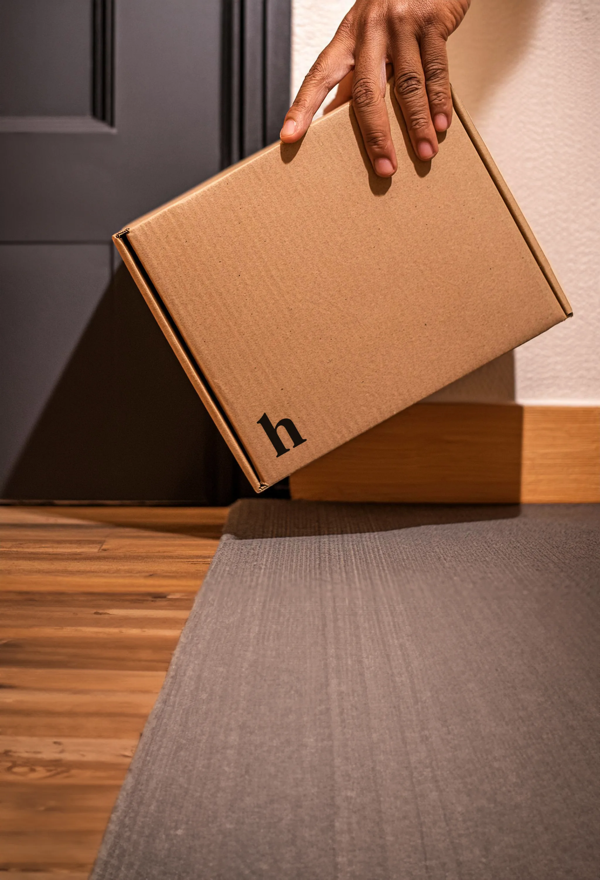 Man picks up a Hims package delivered to his door