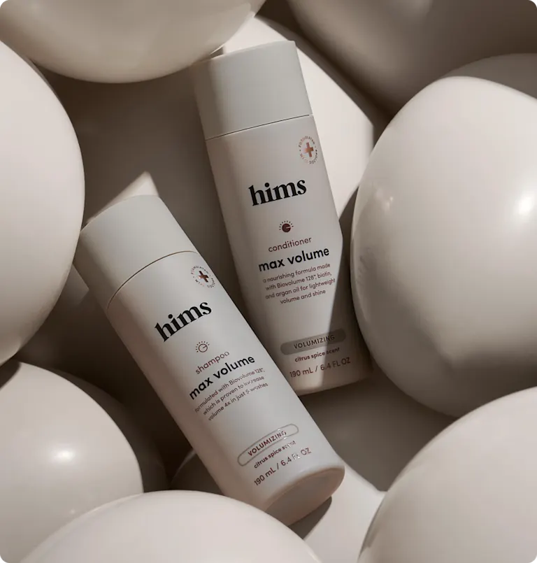 Bottles of shampoo and conditioner by Hims