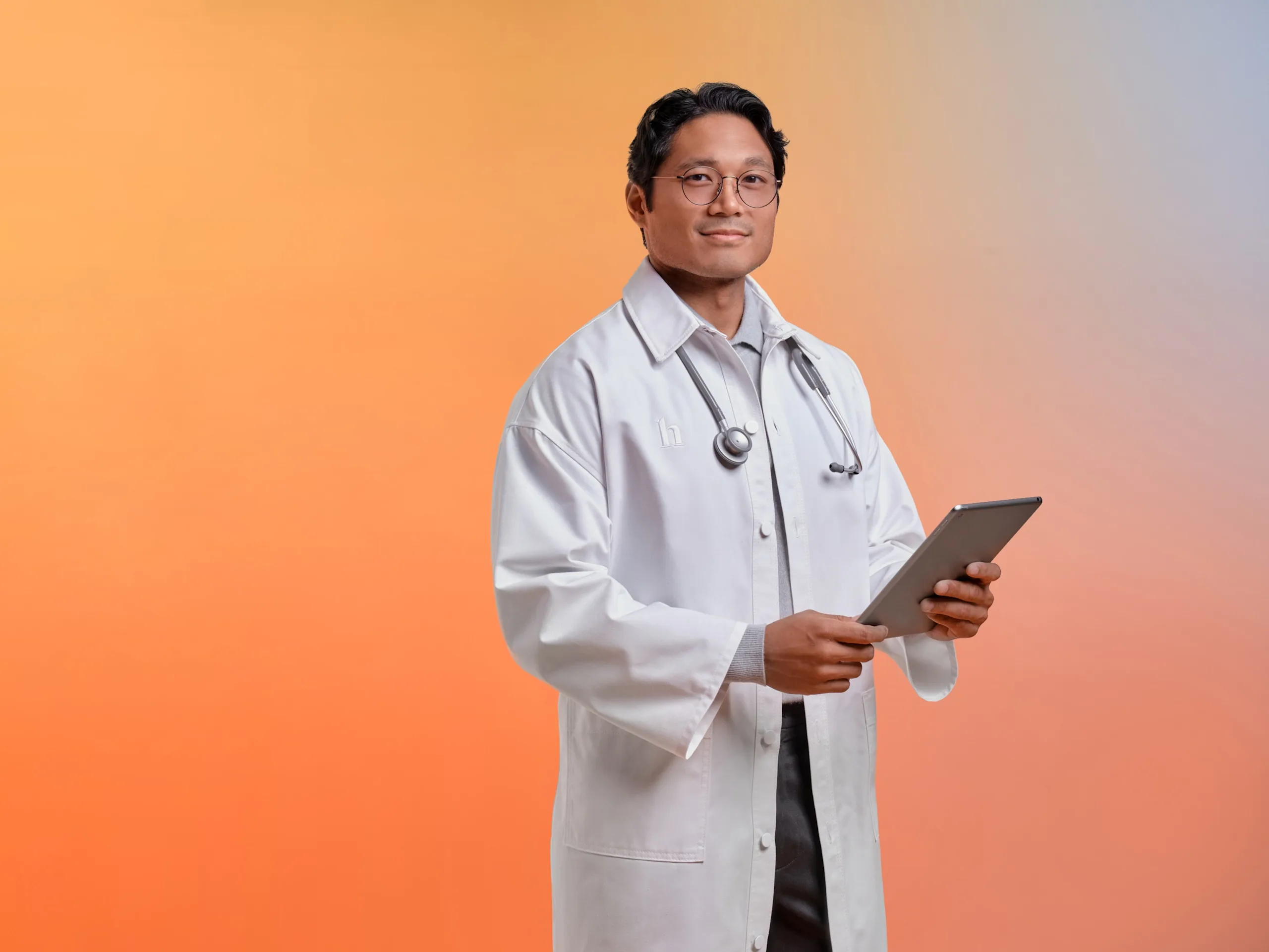 Hims practitioner holds a tablet device