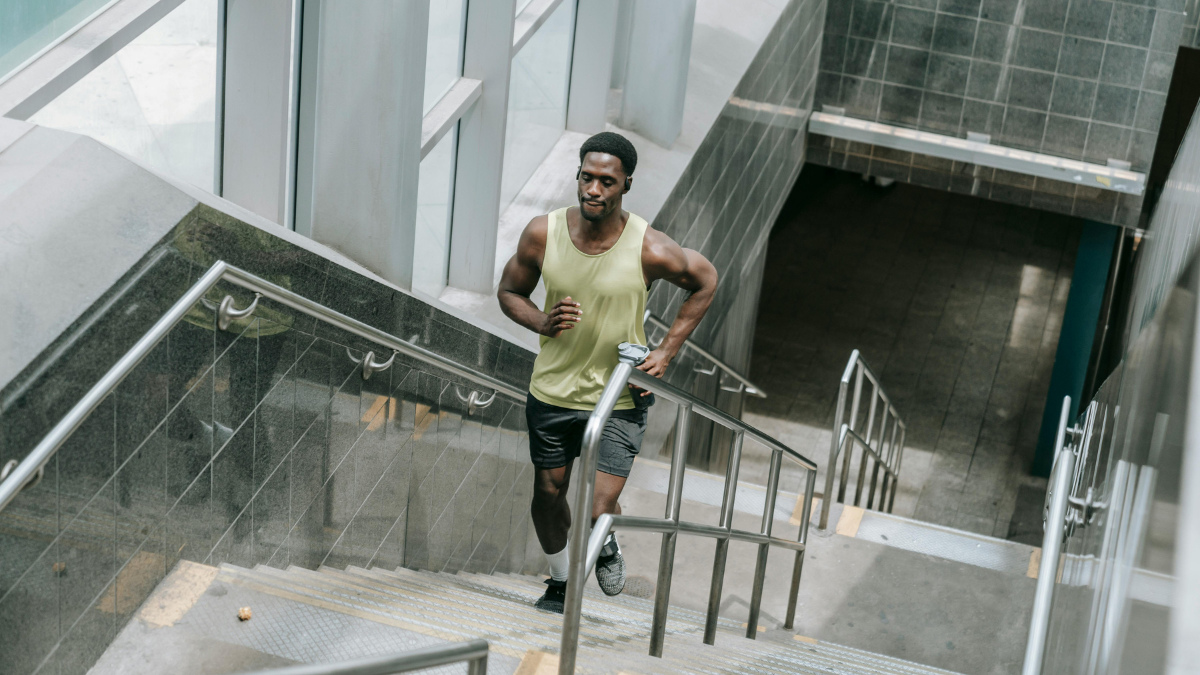 Man running up a flight of stairs to add incidental movement to his day