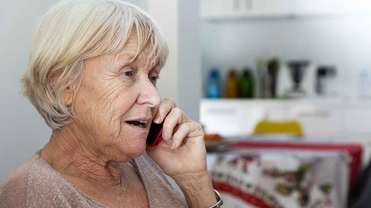 Äldre kvinna pratar i mobiltelefon
