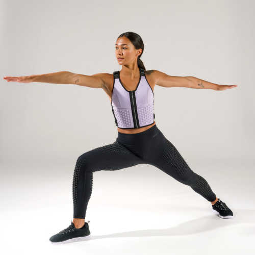 Full body view of woman doing warrior pose in lavender weighted vest by OMORPHO