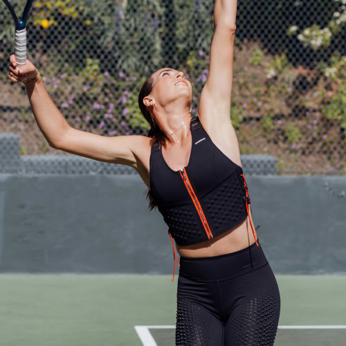 W Sport Bundle - Ajla Tomljanovic serves a tennis ball in the G-Vest Sport and G-Tight weighted gear from OMORPHO.