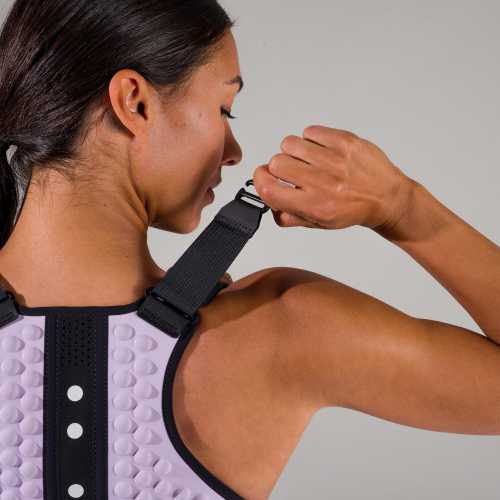 Shoulder detail view of woman adjusting the lavender g-vest weighted vest for women by OMORPHO