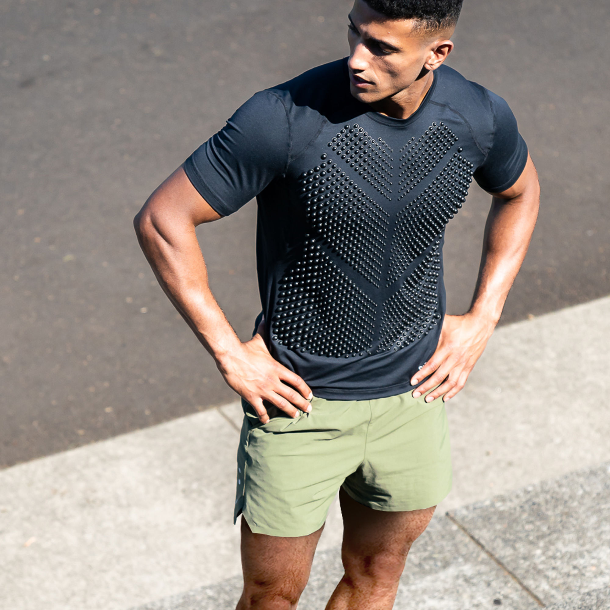 Spring Pack 2023 M Man standing in black weighted top G-Top short sleeve and OMORPHO O-shorts