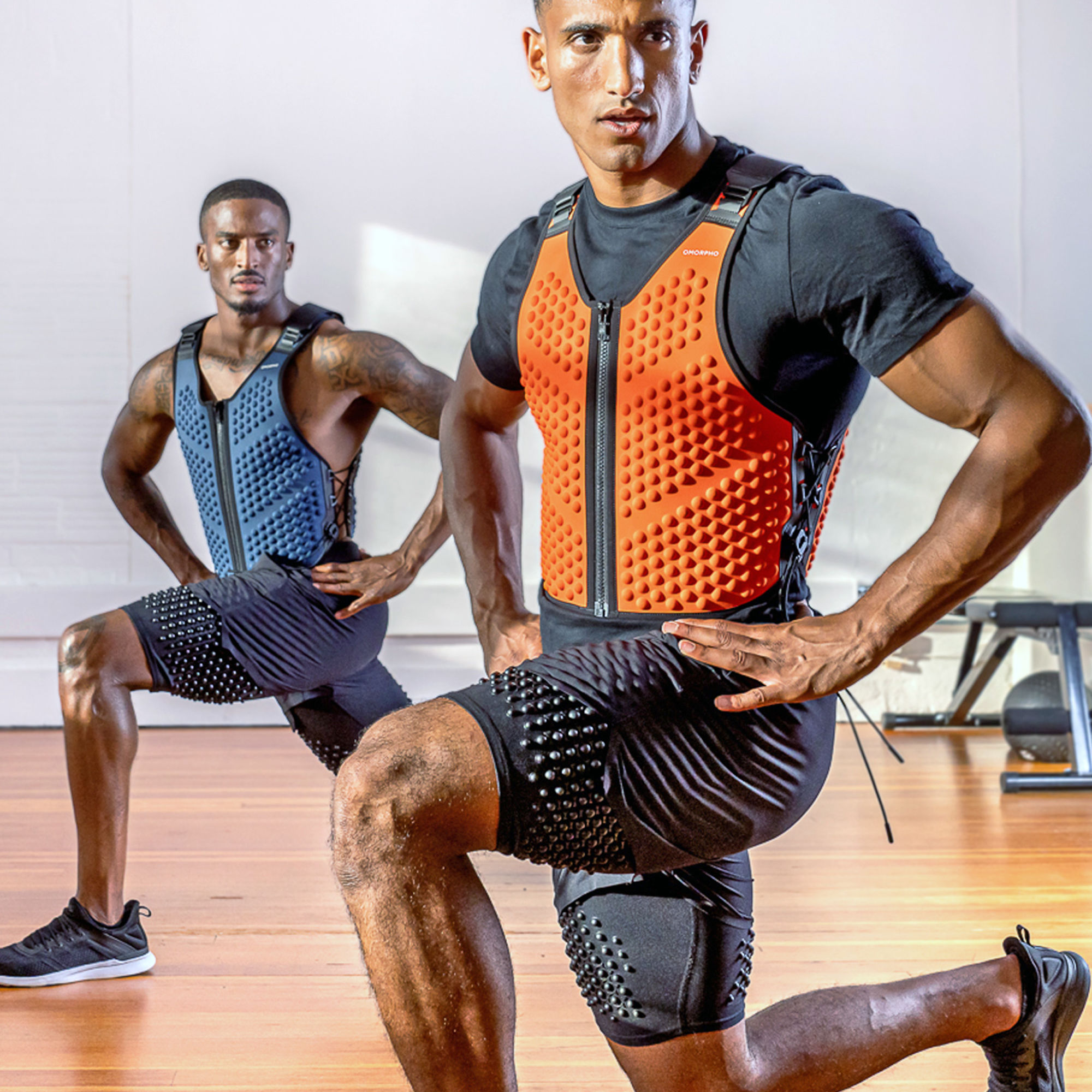 M Strength Bundle - two men lunge in G-Vest ocean and fire and black G-Short 