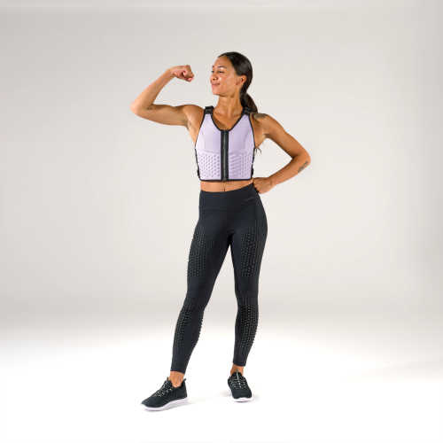 Woman in strength pose wearing OMORPHO g-tights and weighted vest G-vest in lavender