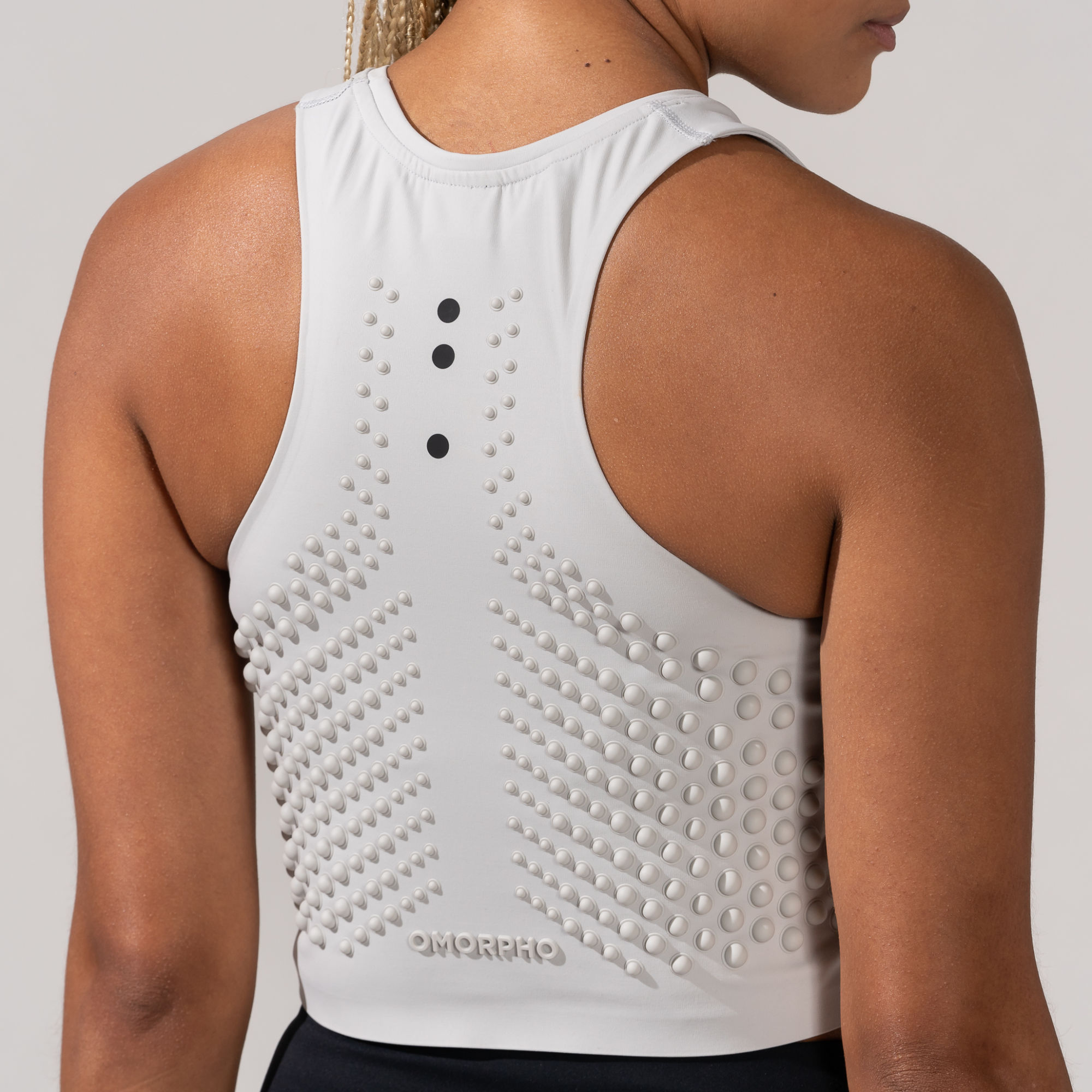 Back view of Female wearing OMORPHO White G-Crop weighted tank top