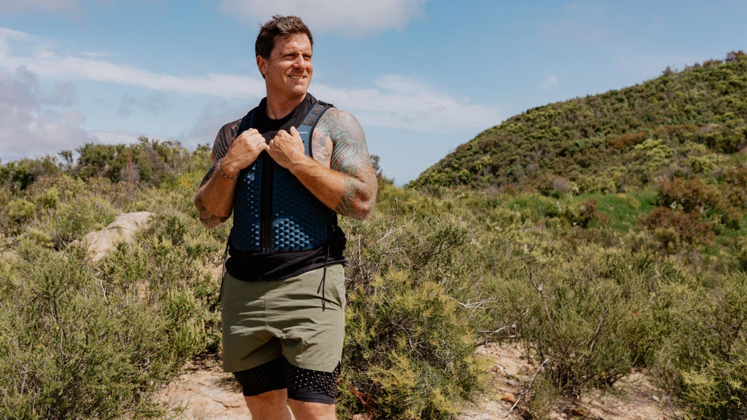 Chef Seamus Mullen walks outdoors in the OMORPHO G-Vest+ and weighted workout shorts
