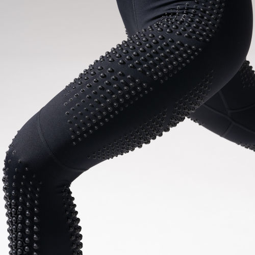 Close-up view of Female wearing OMORPHO Black G-Tight performance leggings