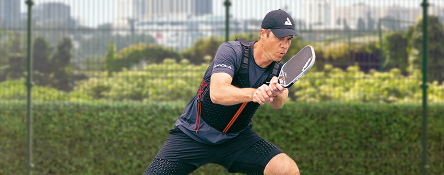 CDP Cover - Desktop - Man plays competitive pickleball in OMORPHO G-Vest Sport and black G-Shorts weight shorts for men